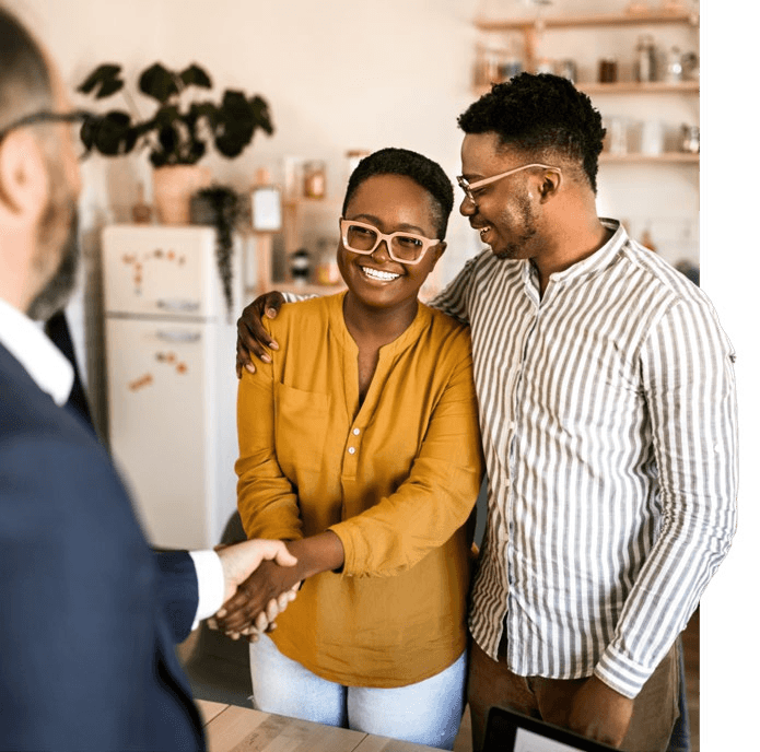 Couple shaking hands with a Belleau advisor